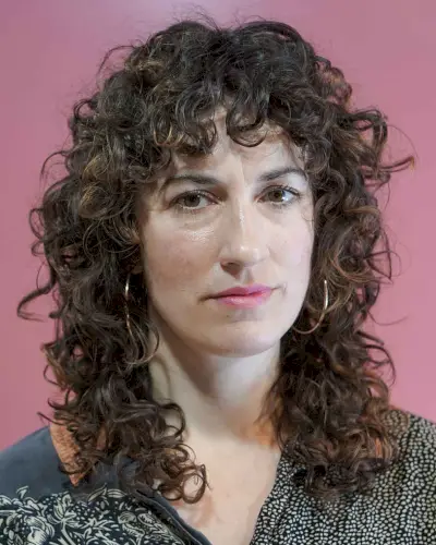 mid-length curly shag cut with curly bangs