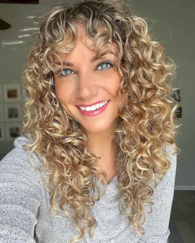 V-Shaped Layered Curls with Wispy Bangs