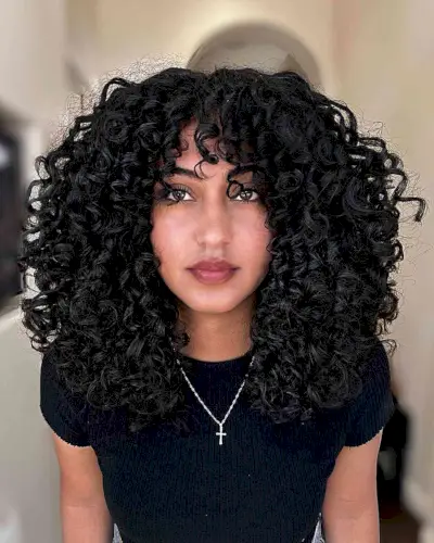 Voluminous Jet Black Curly Hair with Bangs for ladies with thick hair