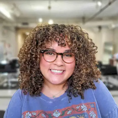 Collarbone-Length Bronde Curls with Bangs