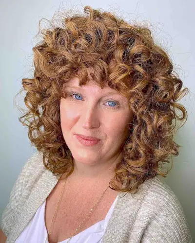 curly natural redhead with bangs