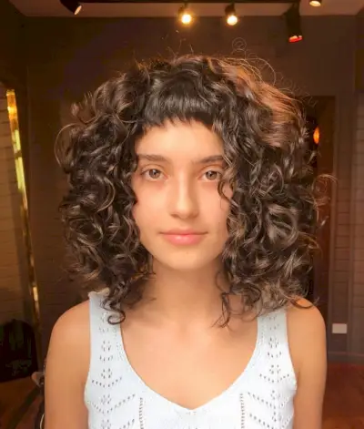 Flattering Short Baby Bangs on Tight Curls