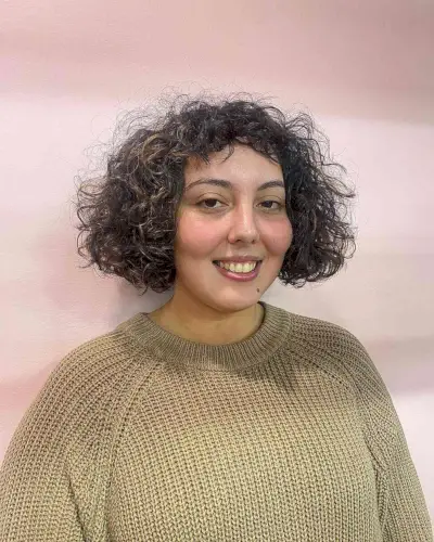 Short Chin-Length Choppy Hair with Frizzy Curls and Micro Bangs