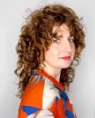 Messy Mid-Length Shaggy Curls with curtain bangs