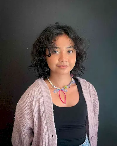 Shoulder-Length Curly Bob with Face-Framing Curtain Bangs