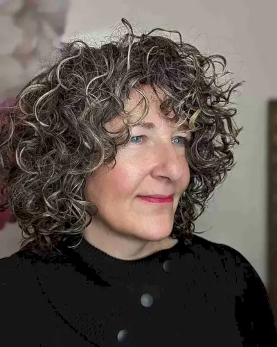 Short Curly Hair with Face-Framing Layers for women aged 60