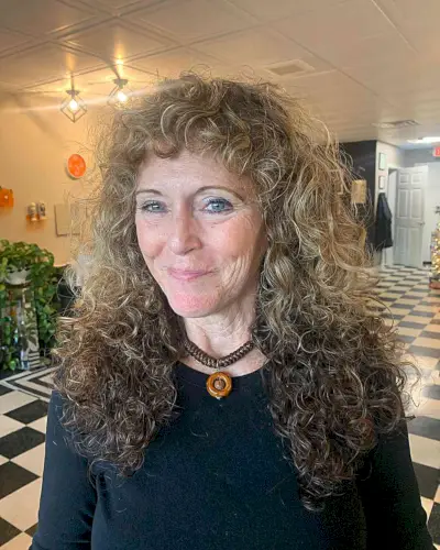 Curly Shag with Long Layers and Short Bangs on ladies in their 60s