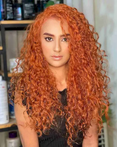 Long Bright Copper Curls with a Side Part