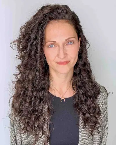 healthy long curly hair with a side part