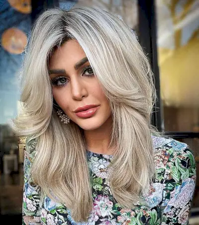 80s-Inspired Chest-Length Classic Blowout Hairstyle with Face-Framing Layers