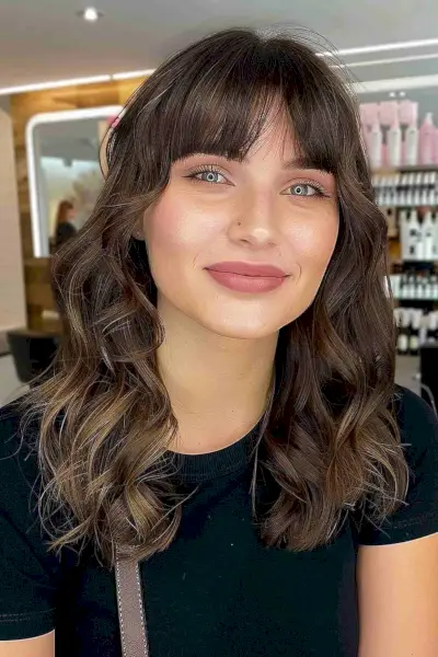 Mid-Length Cut with Blunt Bangs to compliment a square face