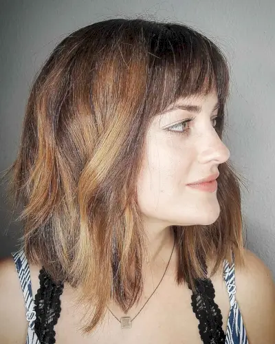 Edgy angled bob with bangs for squared face