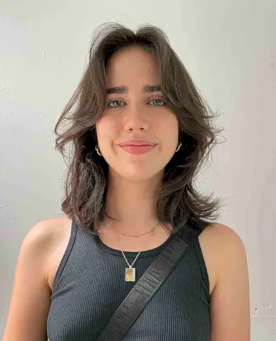 Medium Face-Framing Haircut with Natural Waves for an Oval Face