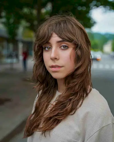 Heavily Layered Shaggy Cut with Curtain Bangs for Oval Face Shapes