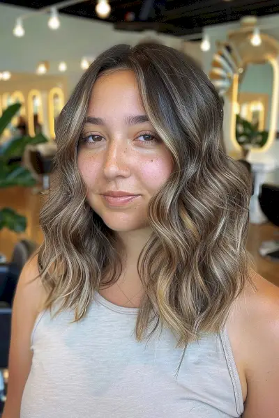 Mid-Length Beach Waves with a Center Part for a Round Face
