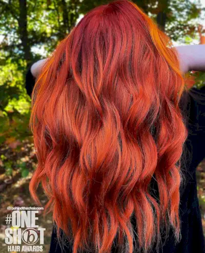 bright red long hair with an orange money piece