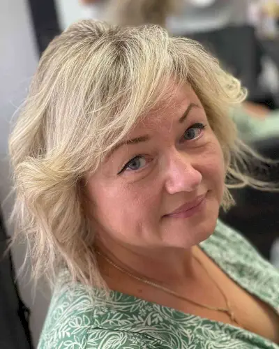 Blonde Feathered Bob with Side-Swept Bangs for Old Women with Fine Hair