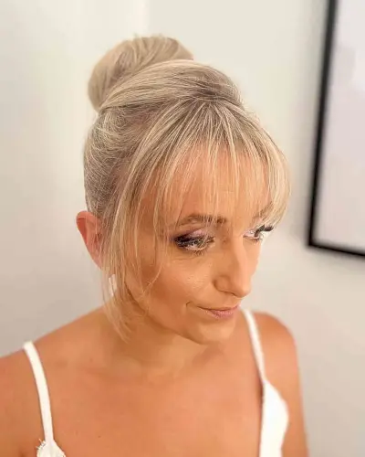 Formal Blonde Ballerina Bun Updo with Thin Bangs on Blonde Hair