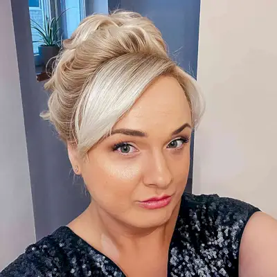 Voluminous High Bun Updo with Side Bangs