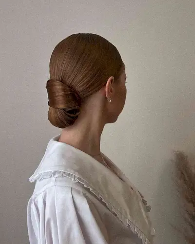 Straight and Sleek Wrapped Low Bun on Dark Copper Hair