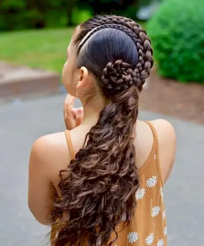 curly hair braided low for homecoming