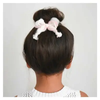 Short top knot style for a toddler