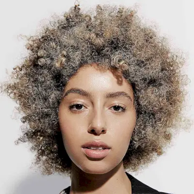 Short Round Curly Hair with Bronde Balayage Highlights