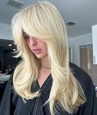 The Perfect Summer Light Blonde Hair Color for women with medium hair and curtain bangs