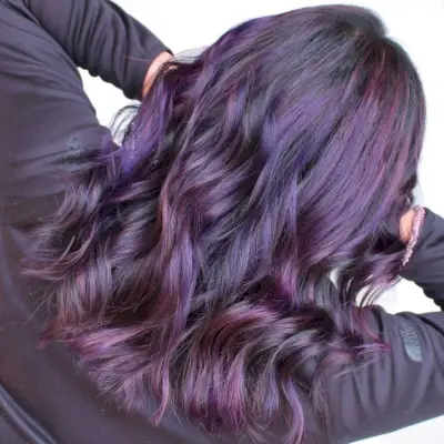 Saturated purple tone on dark tresses