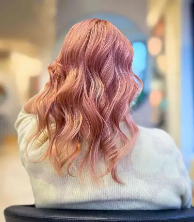 Rosy Gold Strawberry Blonde Hair on Mid-Length Cut with Waves