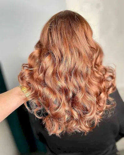 Full Warm Rose Gold Highlights for Medium-Length Loose Curly Hair