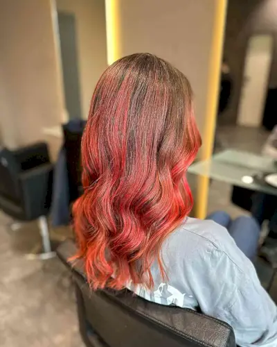 Medium-Length Light Brown Hair with Bright Red Balayage Highlights