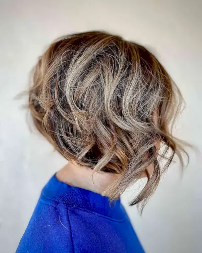Short Layered Bob with Caramel Highlights and Dynamic Curls