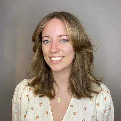 mid-length light brown hair with curtain bangs