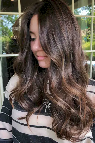 Young Woman with Brunette Layered Hair and Face-Framing Highlights