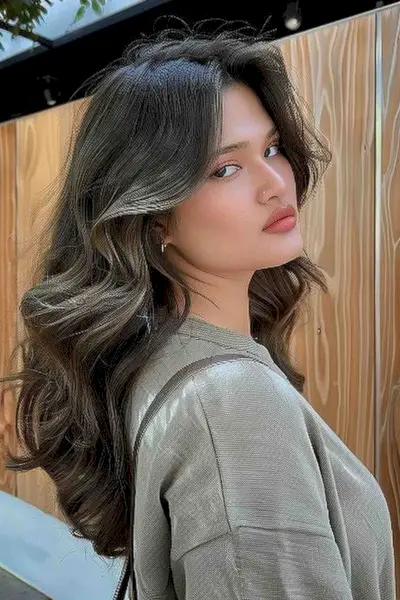 Young Woman with Long Curled Hair and Highlights