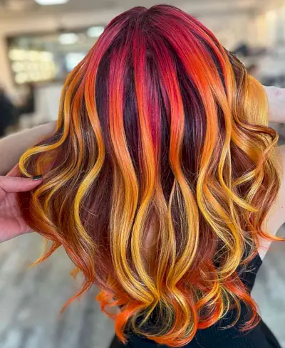 Red, Yellow, and Orange Tones Hair Color Ideas for women with wavy hair