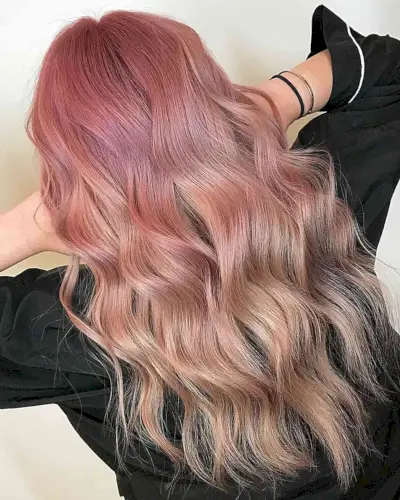 Pink Lemonade Balayage on long wavy hair with wispy ends