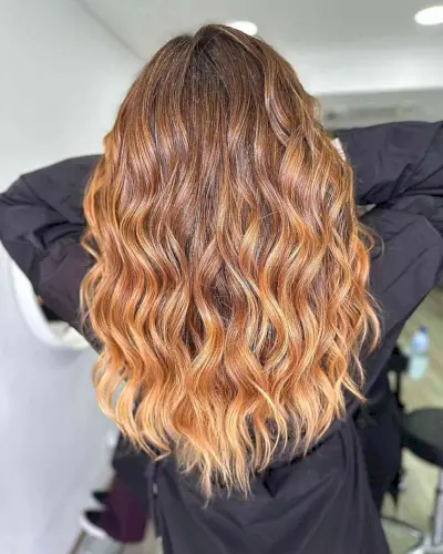 Brown to Golden Blonde Ombre on women with long wavy hair