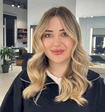 Baby Blonde Longer Hair with Dark Roots and loose curls