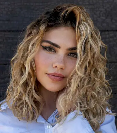 curly blonde hair with dark roots