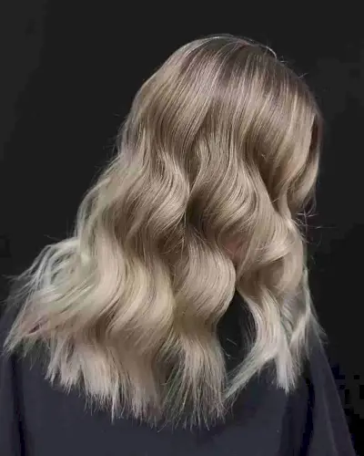 Melted Creamy Dirty Blonde Balayage for Medium to Long Wavy Locks