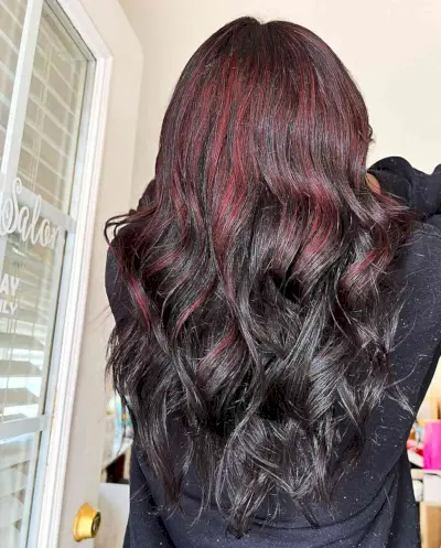 Bold Red Partial Highlights on Long Wavy Dark Hair