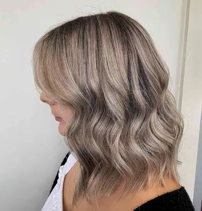 Rooted Dark Mushroom Blonde Balayage for Shoulder-Length Wavy Lob