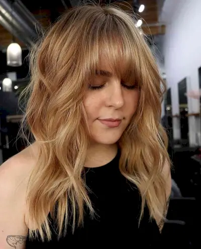 Soft Golden Balayage for Mid-length Choppy Wavy Hair with Bangs