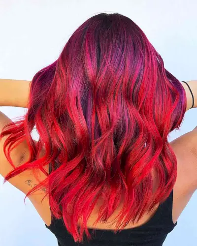 Stunning Bright and Vivid Red Balayage Hair Color on medium-length wavy hair