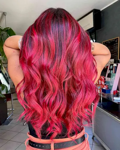 Vivid Red Balayage with Dark Roots for women with long wavy hair