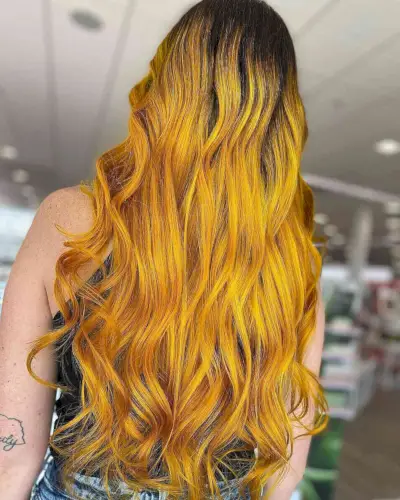 Long hair with dark roots and brassy yellow locks