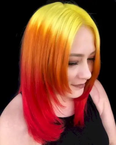 Medium length layered cut with yellow to orange to red color