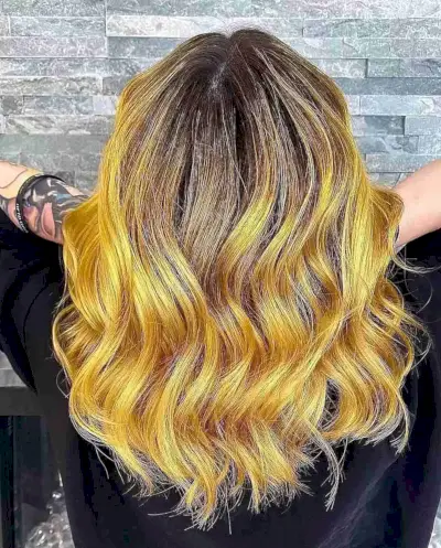 medium-length haircut with mustard yellow balayage